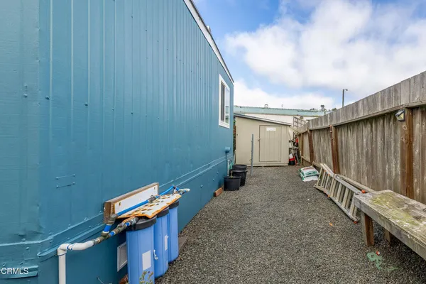 a backyard of a house with wooden stairs and stairs