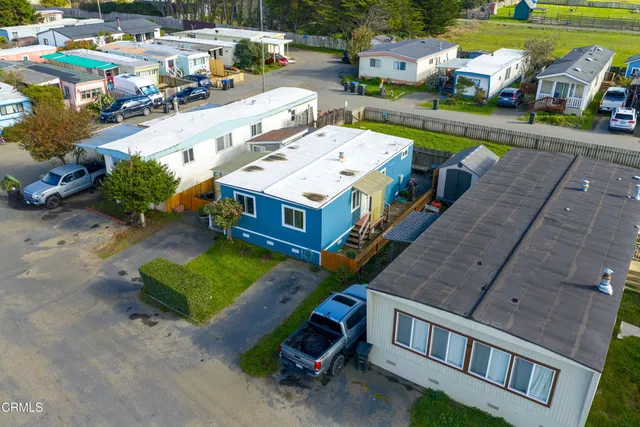 an aerial view of a house with a yard basket ball court
