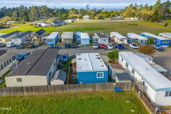 an aerial view of a house with a swimming pool outdoor seating and yard