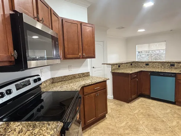 a kitchen with a stove a sink and a microwave