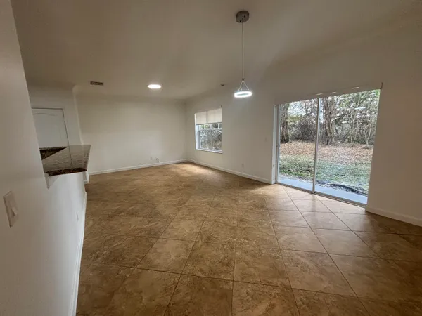 a view of a livingroom with a ceiling fan and window