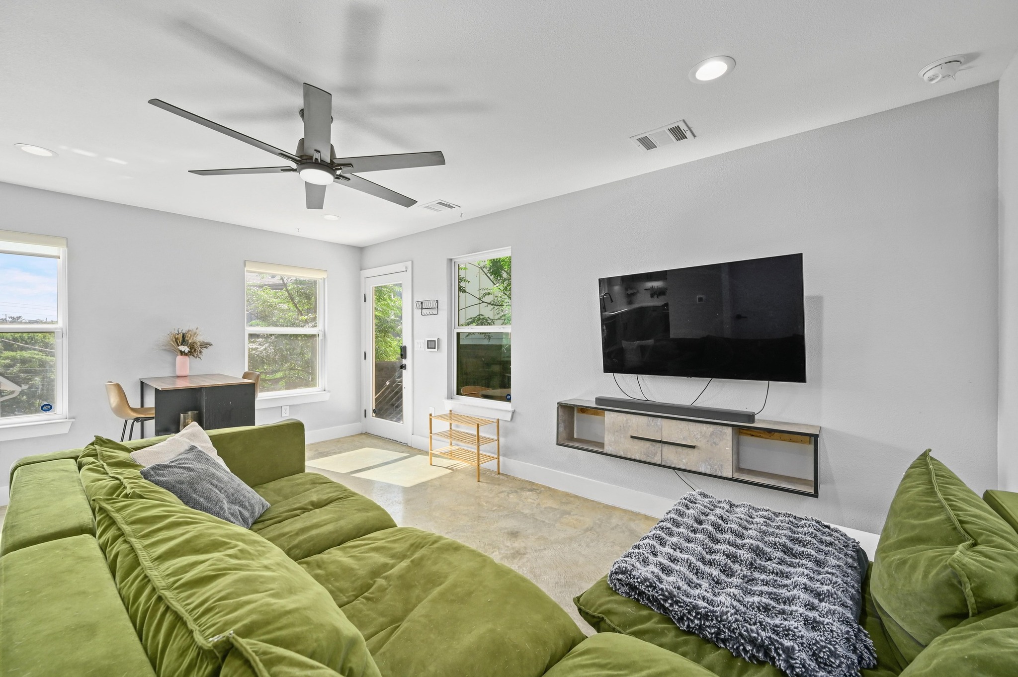 1210 Luna Street, Unit 2 Austin, TX 78721 - Photo 2 of 17 a living room with furniture and a flat screen tv
