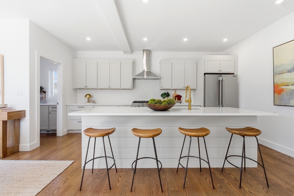 51 Fox Hill Road Nahant, MA 01908 - Photo 9 of 36 a kitchen with stainless steel appliances kitchen island granite countertop a dining table chairs and a refrigerator