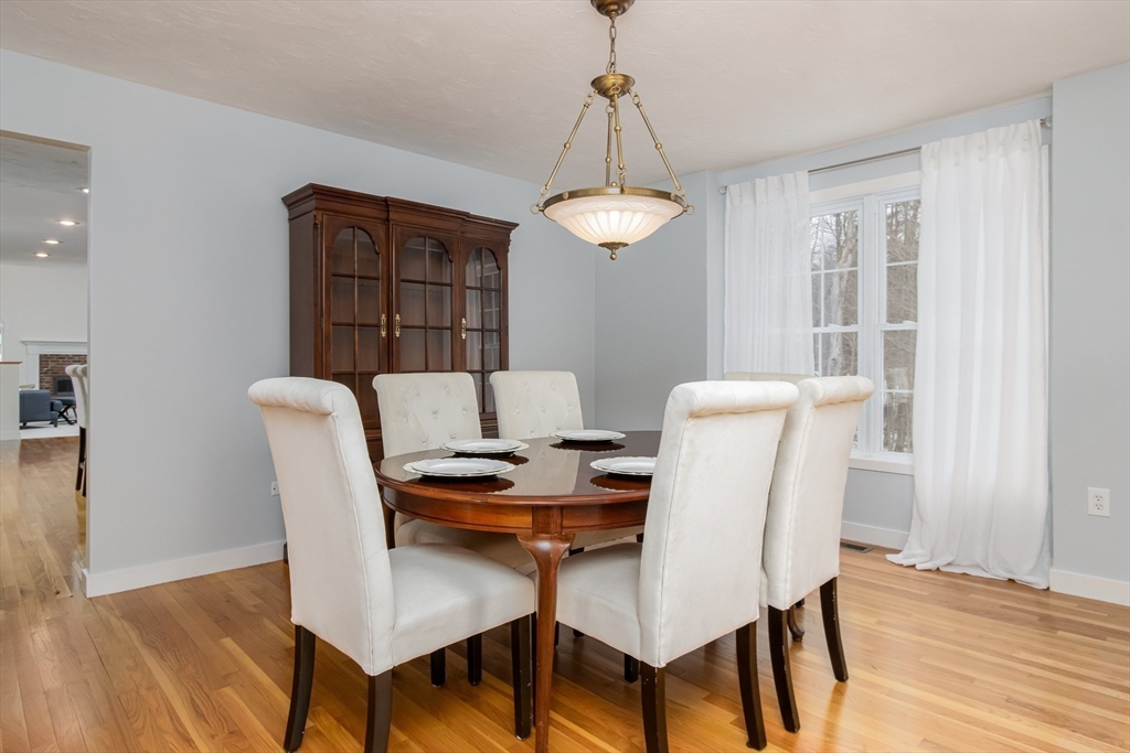 1 Integrity Way Groton, MA 01450 - Photo 12 of 36 a view of a dining room with furniture wooden floor and chandelier
