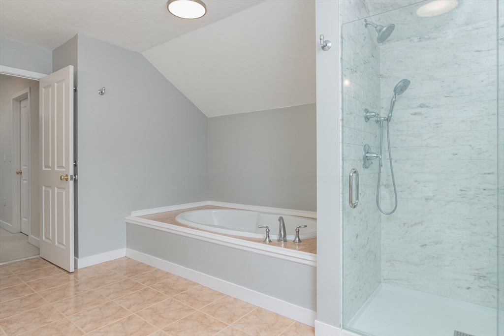 1 Integrity Way Groton, MA 01450 - Photo 20 of 36 a bathroom with a bathtub and a shower