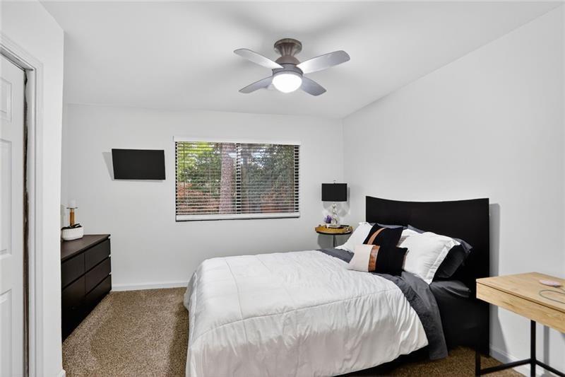 3306 Northcrest Road, Unit A Atlanta, GA 30340 - Photo 13 of 27 a bedroom with a bed and a flat tv screen on a dresser