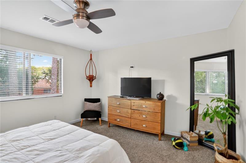 3306 Northcrest Road, Unit A Atlanta, GA 30340 - Photo 20 of 27 a bedroom with a bed and a flat tv screen on the dresser