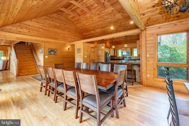 a living room with furniture a fireplace and a floor to ceiling window