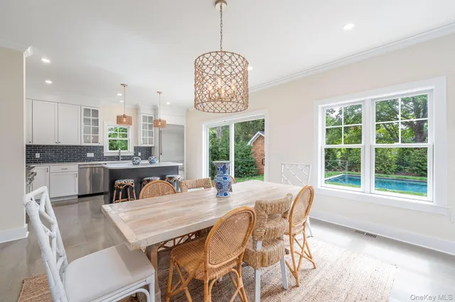 a dining room with furniture a chandelier and window