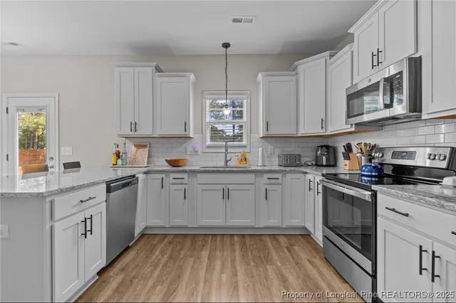 a kitchen with cabinets and window