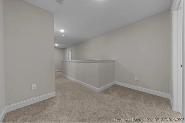 a view of a kitchen with refrigerator and wooden floor