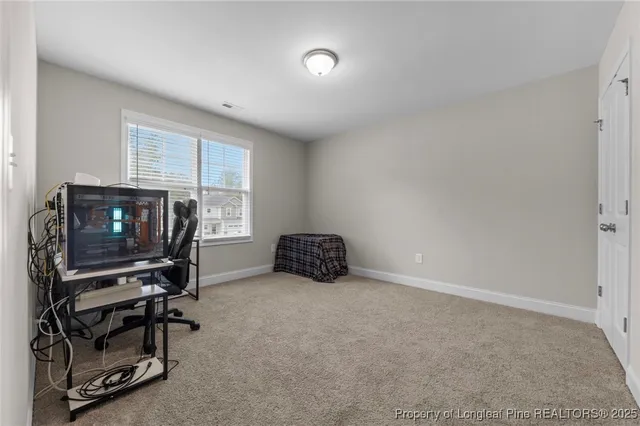 an empty room with windows and entrance to other room