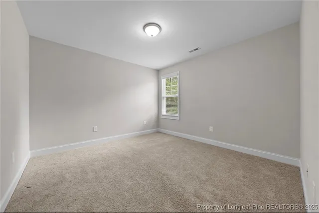 a spacious bathroom with a granite countertop sink a toilet and a mirror