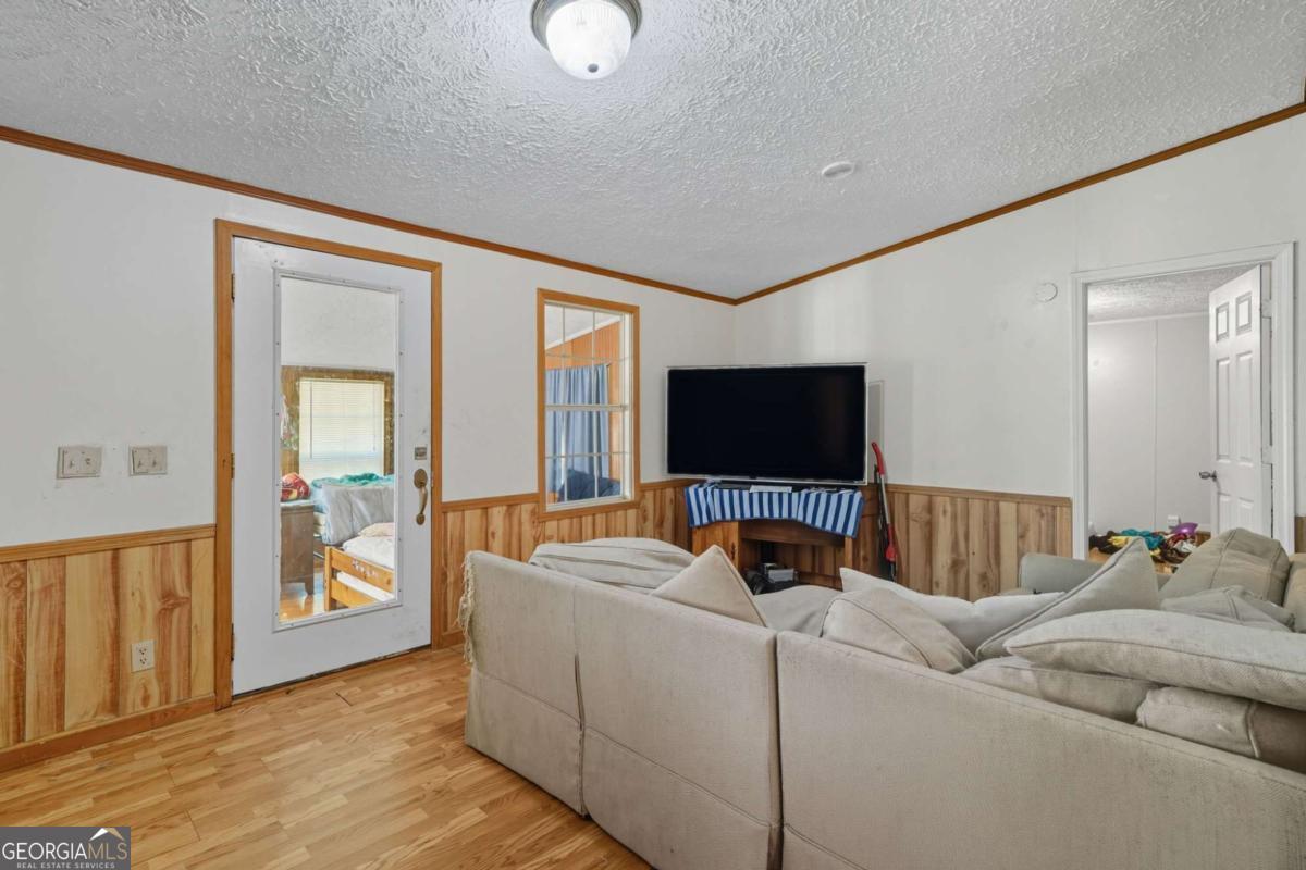 2450 Jones Mountain Road Talking Rock, GA 30175 - Photo 11 of 40 a living room with furniture and a flat screen tv