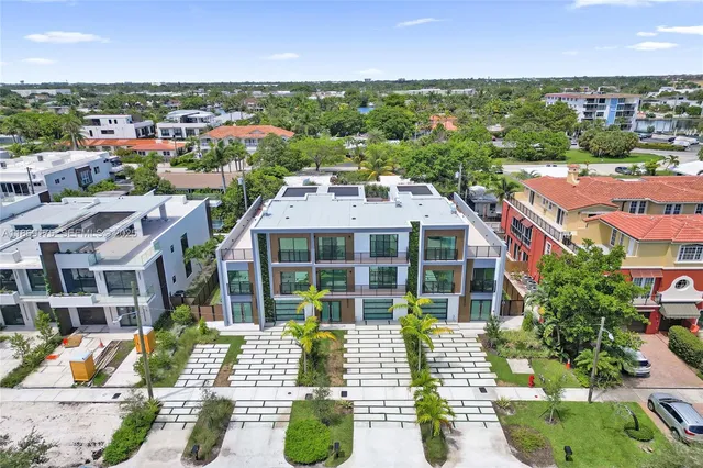 an aerial view of residential houses with city view