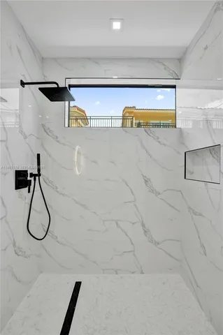 a bathroom with a toilet sink vanity and shower