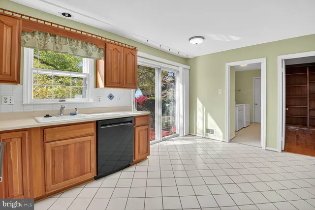 a kitchen with a sink cabinets and wooden floor