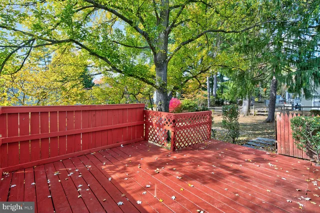 a wooden bench sitting in front of a house