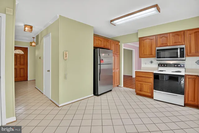 a kitchen with stainless steel appliances a refrigerator and a stove top oven