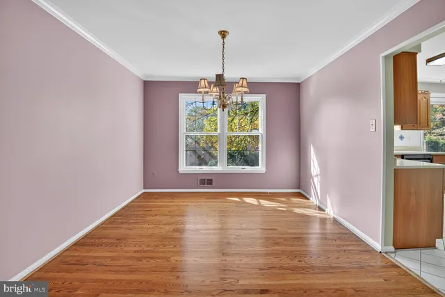 a view of empty room with window and outdoor space