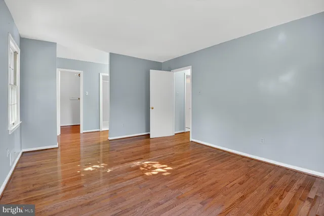 a view of an empty room and wooden floor