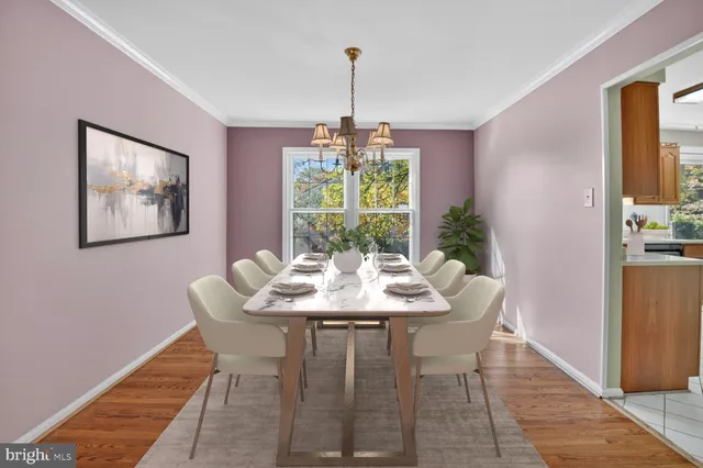 a dining room with furniture a chandelier and wooden floor