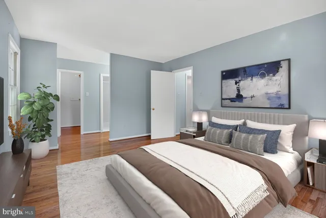 a bedroom with bed and wooden floor