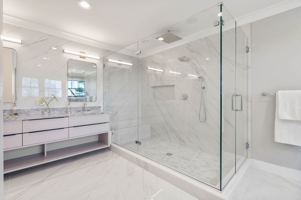 258 Greendale Avenue Needham, MA 02494 - Photo 16 of 23 a bathroom with a shower a sink a mirror and a shower