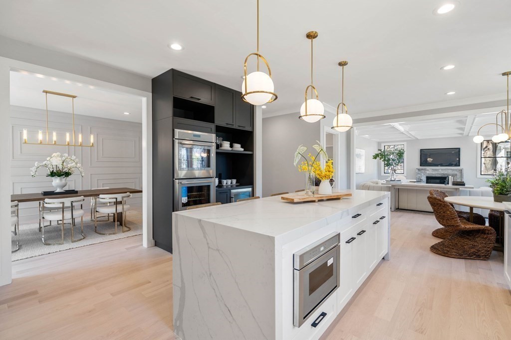 258 Greendale Avenue Needham, MA 02494 - Photo 5 of 23 a large kitchen with kitchen island a large counter space a sink appliances and living room view