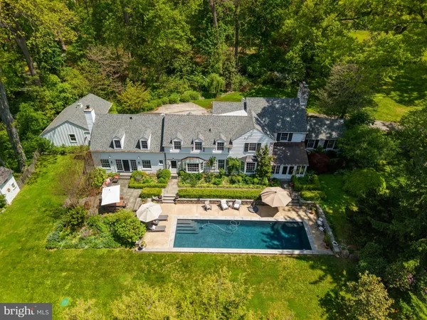 a front view of a house with swimming pool having outdoor seating