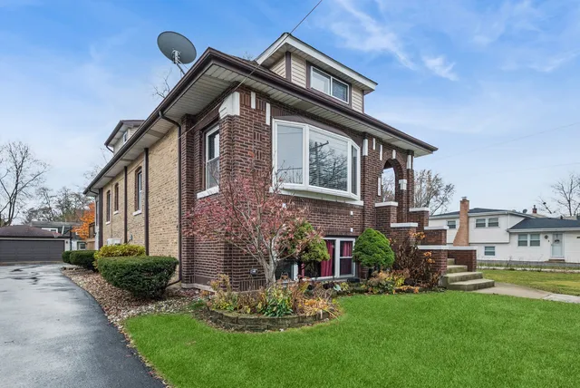 a front view of house with a garden