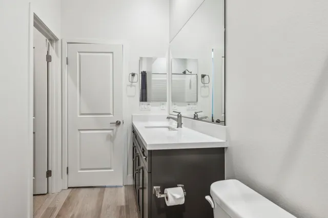 a bathroom with a sink and mirror with toilet