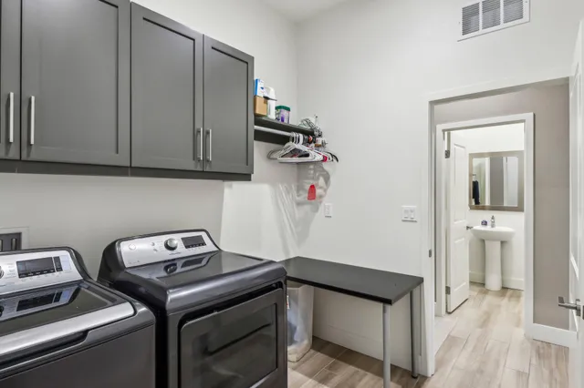 a bed sitting in a bedroom next to a window and a lamp