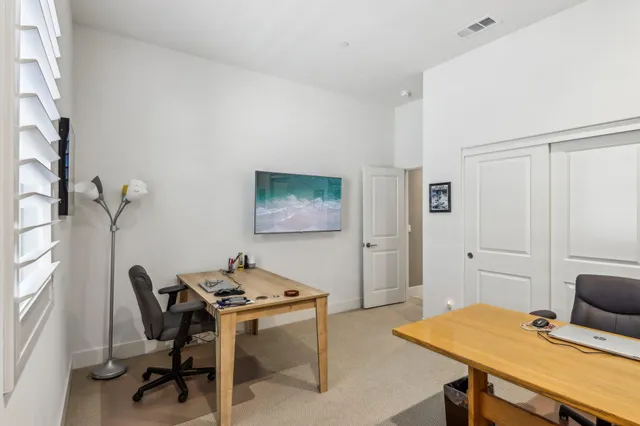a view of a terrace with chairs and an umbrella