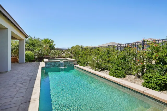 a view of a swimming pool with outdoor seating