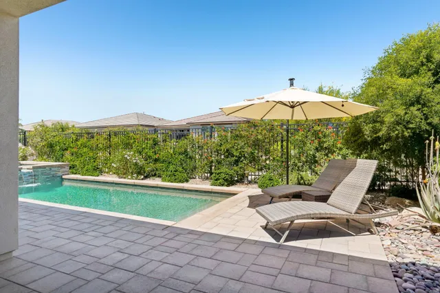 a view of a chairs and table in patio with a lake view