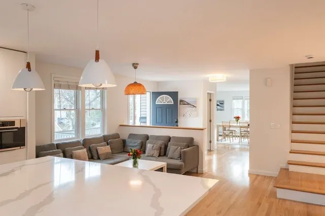 a kitchen with kitchen island a large window and appliances