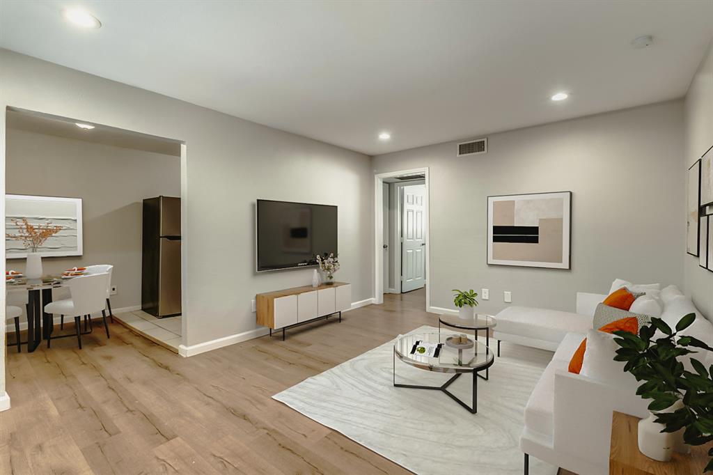 4618 Reiger Avenue, Unit 211 Dallas, TX 75246 - Photo 1 of 19 a living room with furniture and a flat screen tv