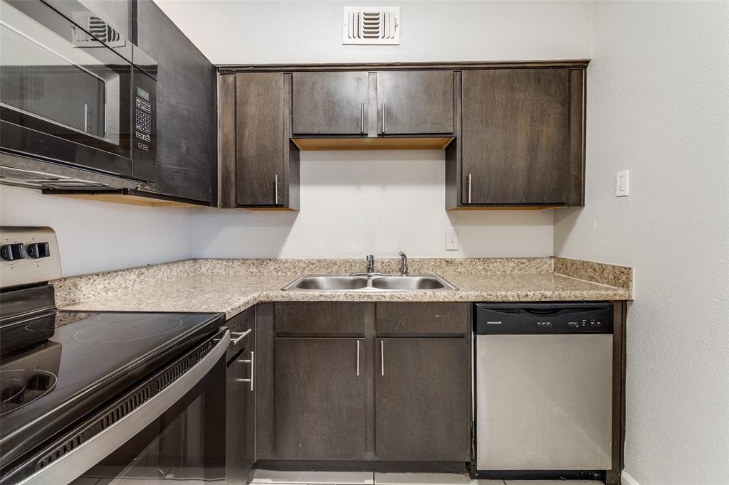 4618 Reiger Avenue, Unit 211 Dallas, TX 75246 - Photo 14 of 19 a kitchen with granite countertop a sink and a stove