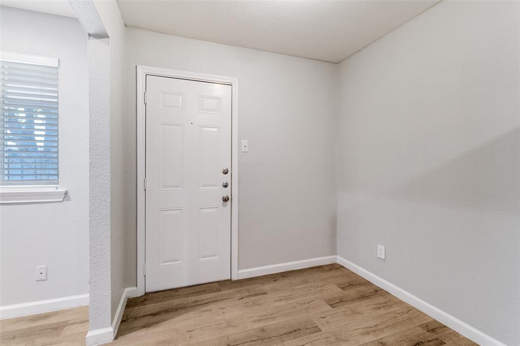 4618 Reiger Avenue, Unit 211 Dallas, TX 75246 - Photo 15 of 19 an empty room with wooden floor and closet
