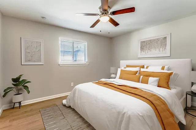 a bedroom with bed and a window