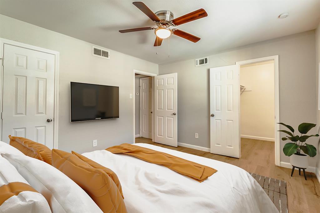 4618 Reiger Avenue, Unit 211 Dallas, TX 75246 - Photo 3 of 19 a bedroom with a bed and a flat screen tv