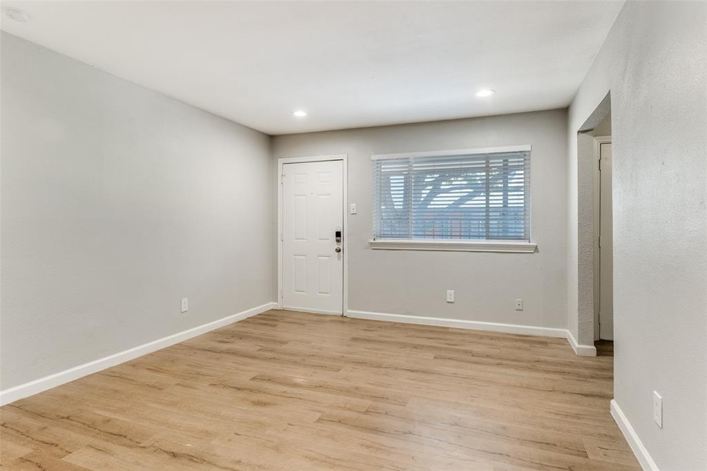 4618 Reiger Avenue, Unit 211 Dallas, TX 75246 - Photo 10 of 19 wooden floor in an empty room with a window