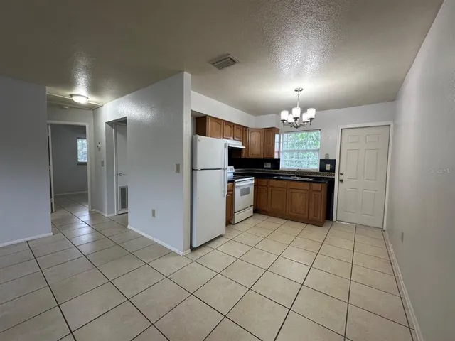 a kitchen with stainless steel appliances a refrigerator sink and cabinets
