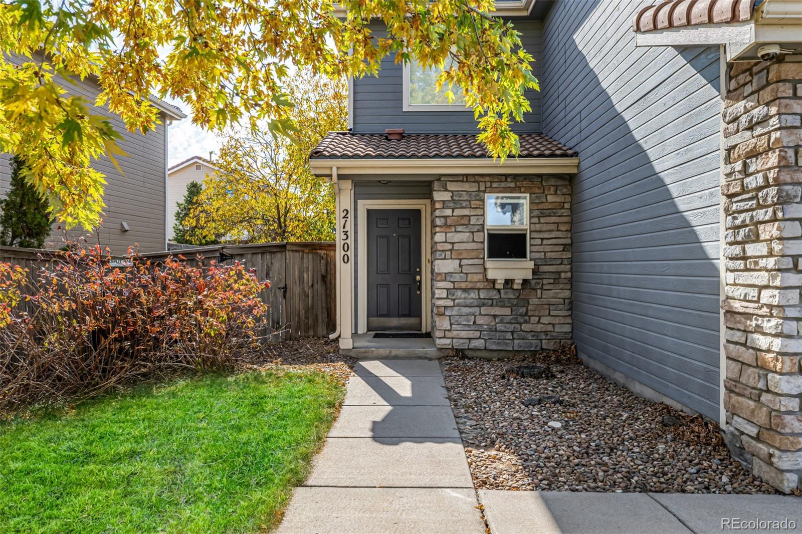 21300 East 42nd Avenue Denver, CO 80249 - Photo 11 of 48 a front view of a house with a garden