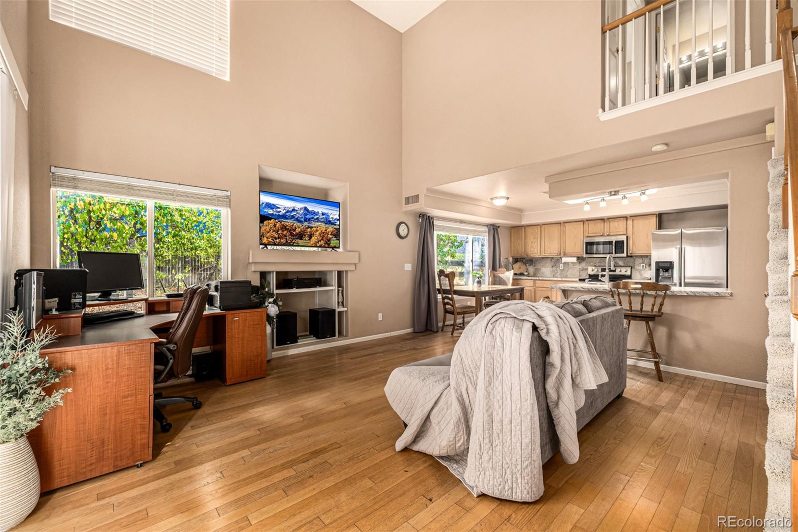21300 East 42nd Avenue Denver, CO 80249 - Photo 12 of 48 a living room with furniture a fireplace and gym equipment