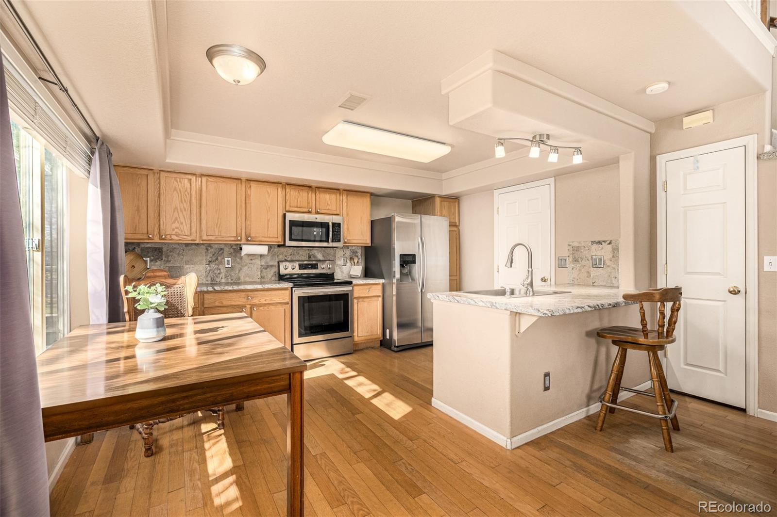 21300 East 42nd Avenue Denver, CO 80249 - Photo 15 of 48 a kitchen with a sink cabinets and window