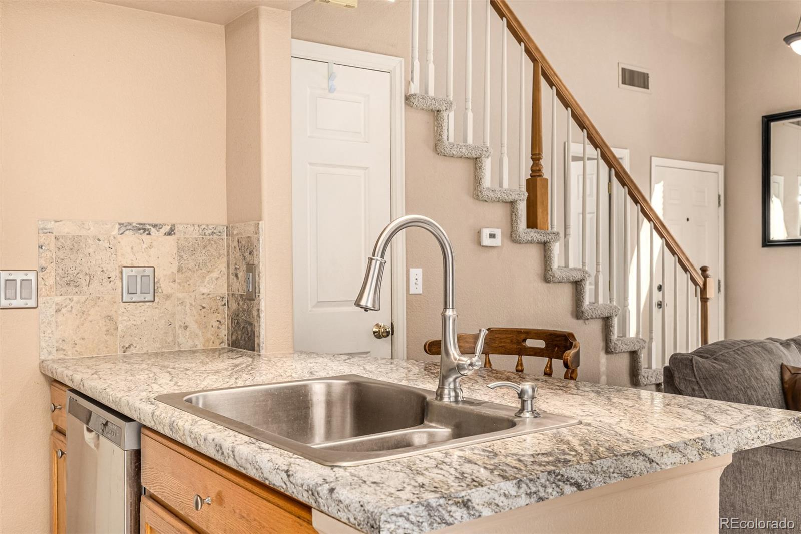 21300 East 42nd Avenue Denver, CO 80249 - Photo 18 of 48 a kitchen with a granite countertop sink and natural light