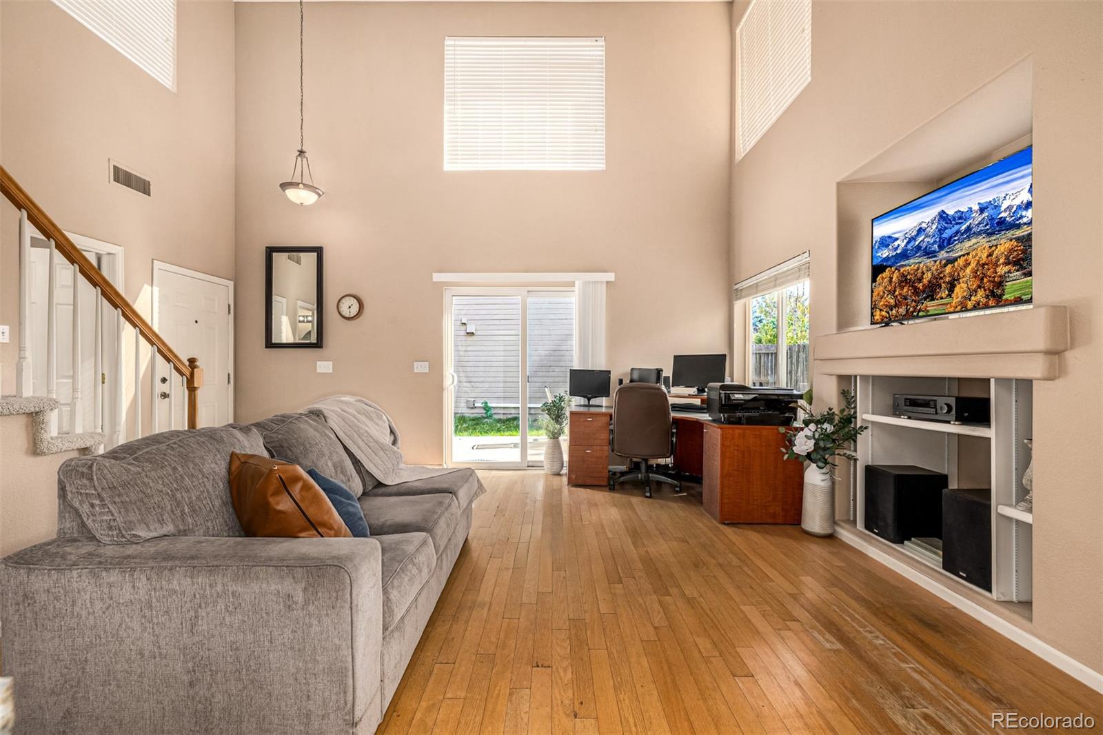 21300 East 42nd Avenue Denver, CO 80249 - Photo 23 of 48 a living room with furniture a fireplace and a flat screen tv