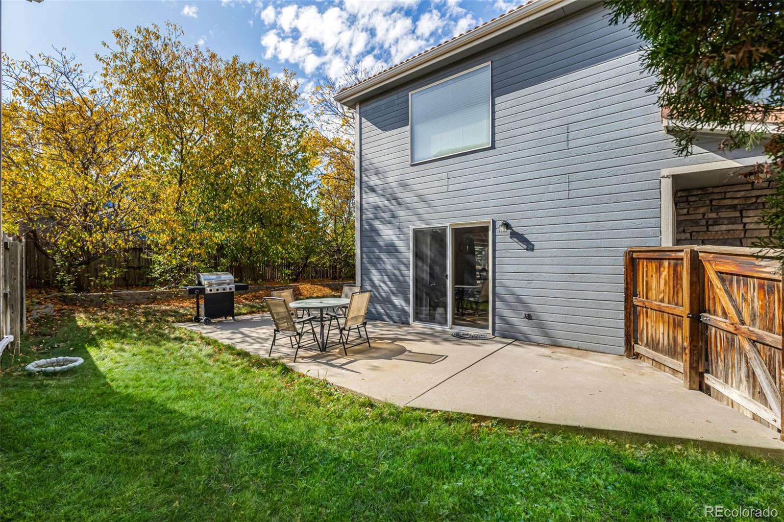 21300 East 42nd Avenue Denver, CO 80249 - Photo 25 of 48 a backyard of a house with table and chairs